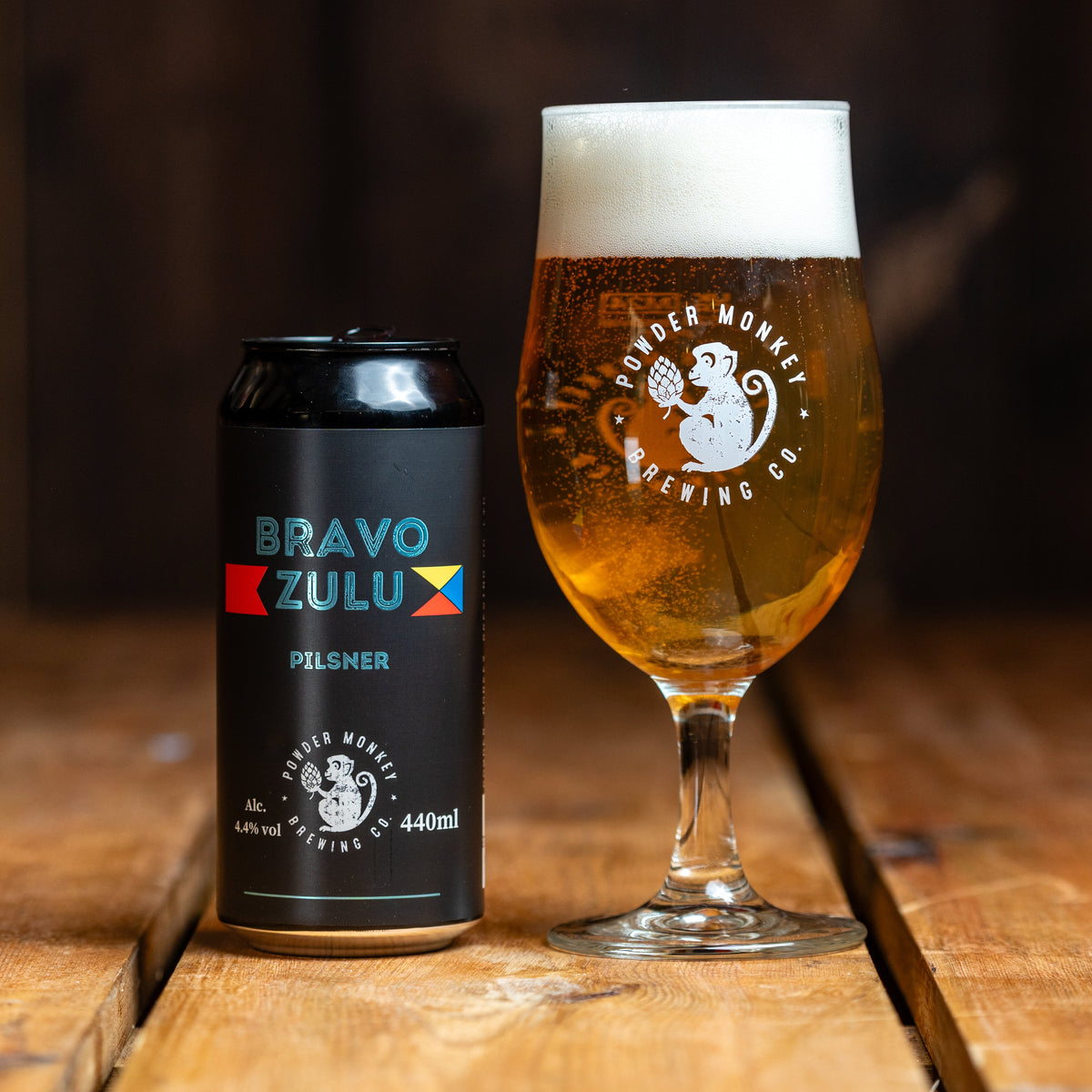 Can and glass of Bravo Zulu Pilsner from Powder Monkey Brewing Co