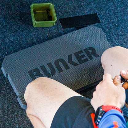 A person kneeling on the Bunker Cushion