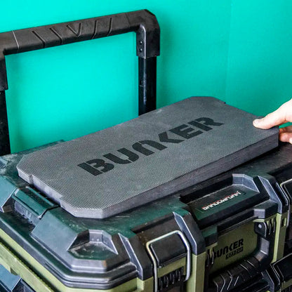 Dark gray BUNKER brand protective Cushion resting on top of a hard case