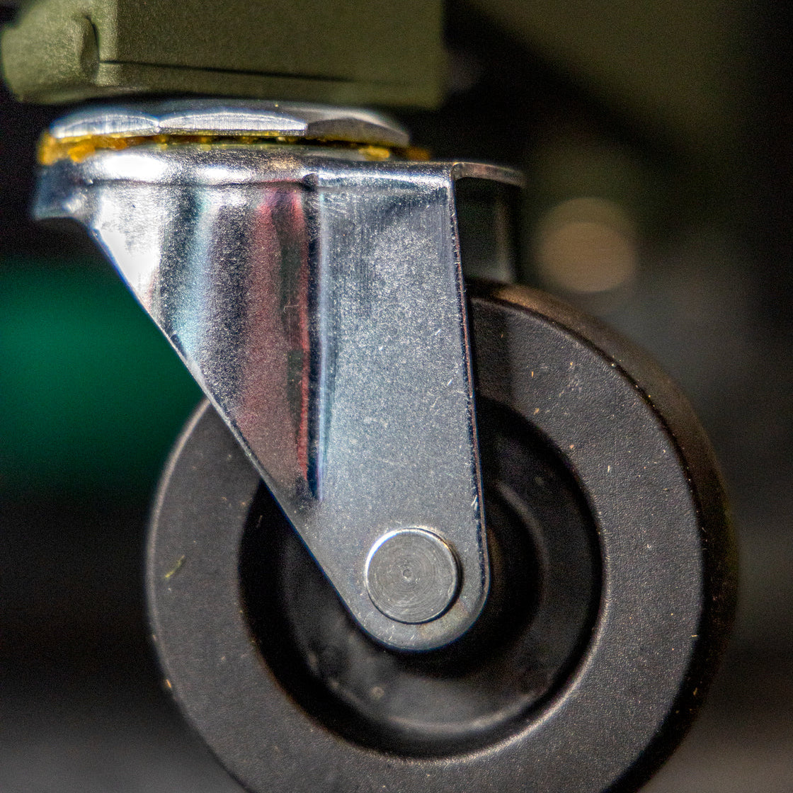 Close-up of a black caster wheel on the BUNKER Adjustable Work Stool