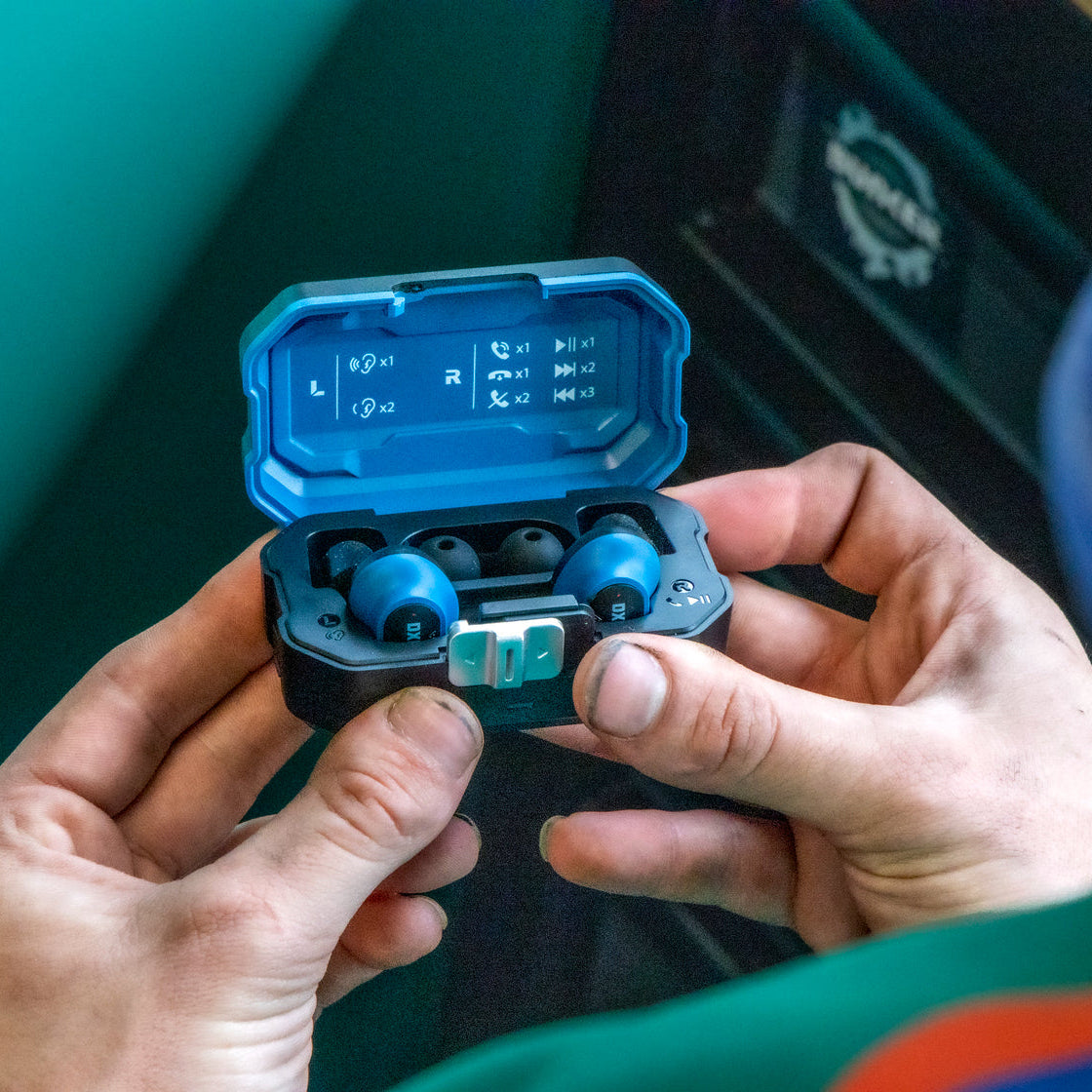 Man holding the DXPULSE Noise Isolating Earbuds with Charging Case