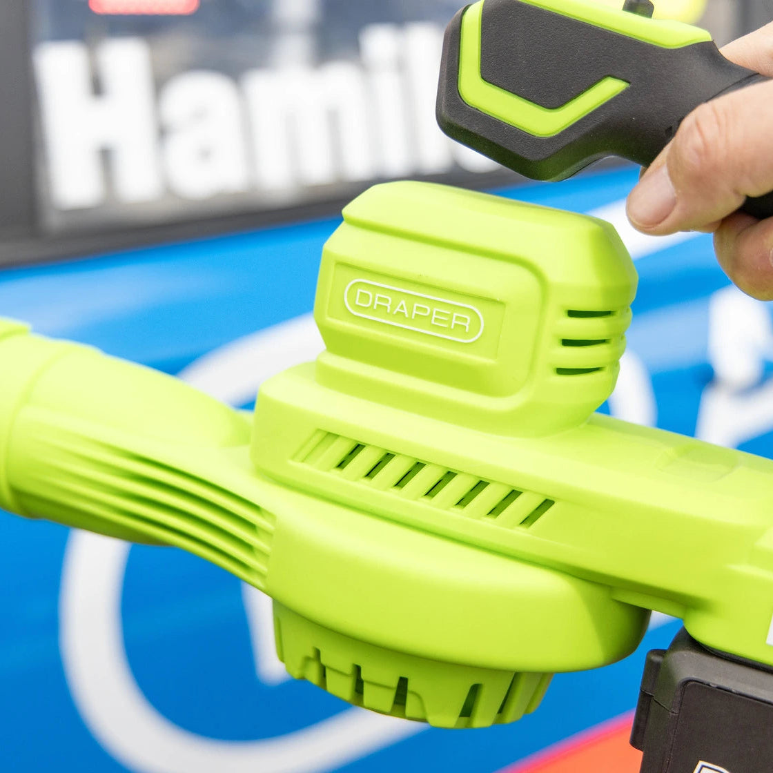 A close-up of a green and black Draper cordless leaf blower