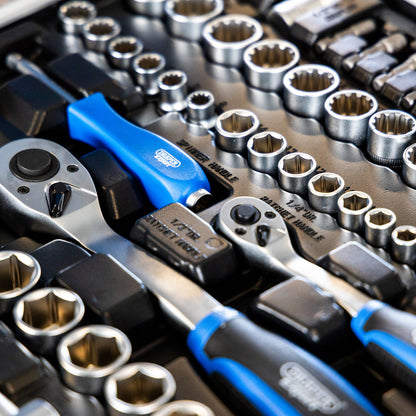 A close-up of a socket wrench and socket set with silver metal sockets, ratchets, and sockets 