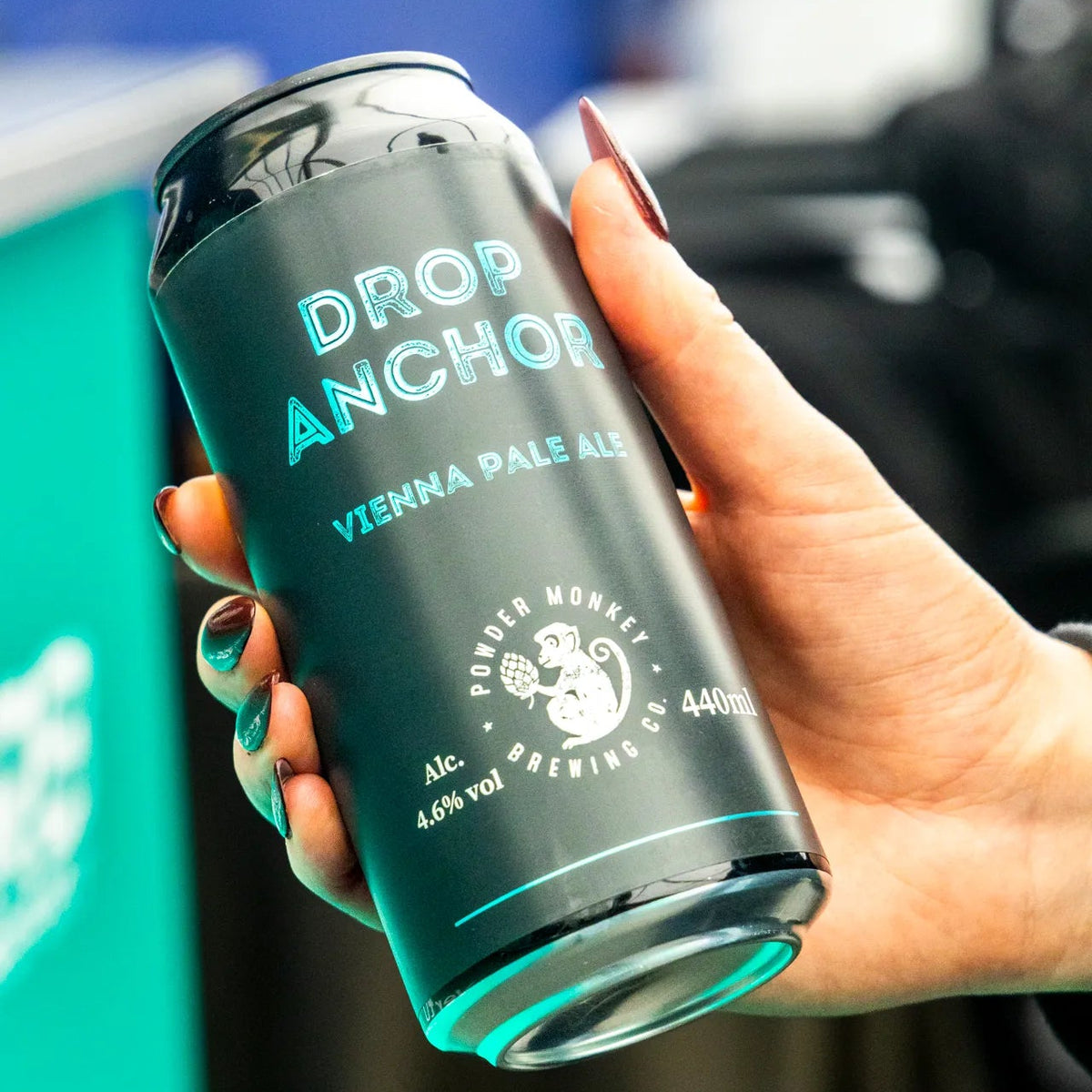 A hand holding a black aluminium can of Drop Anchor Vienna Pale Ale