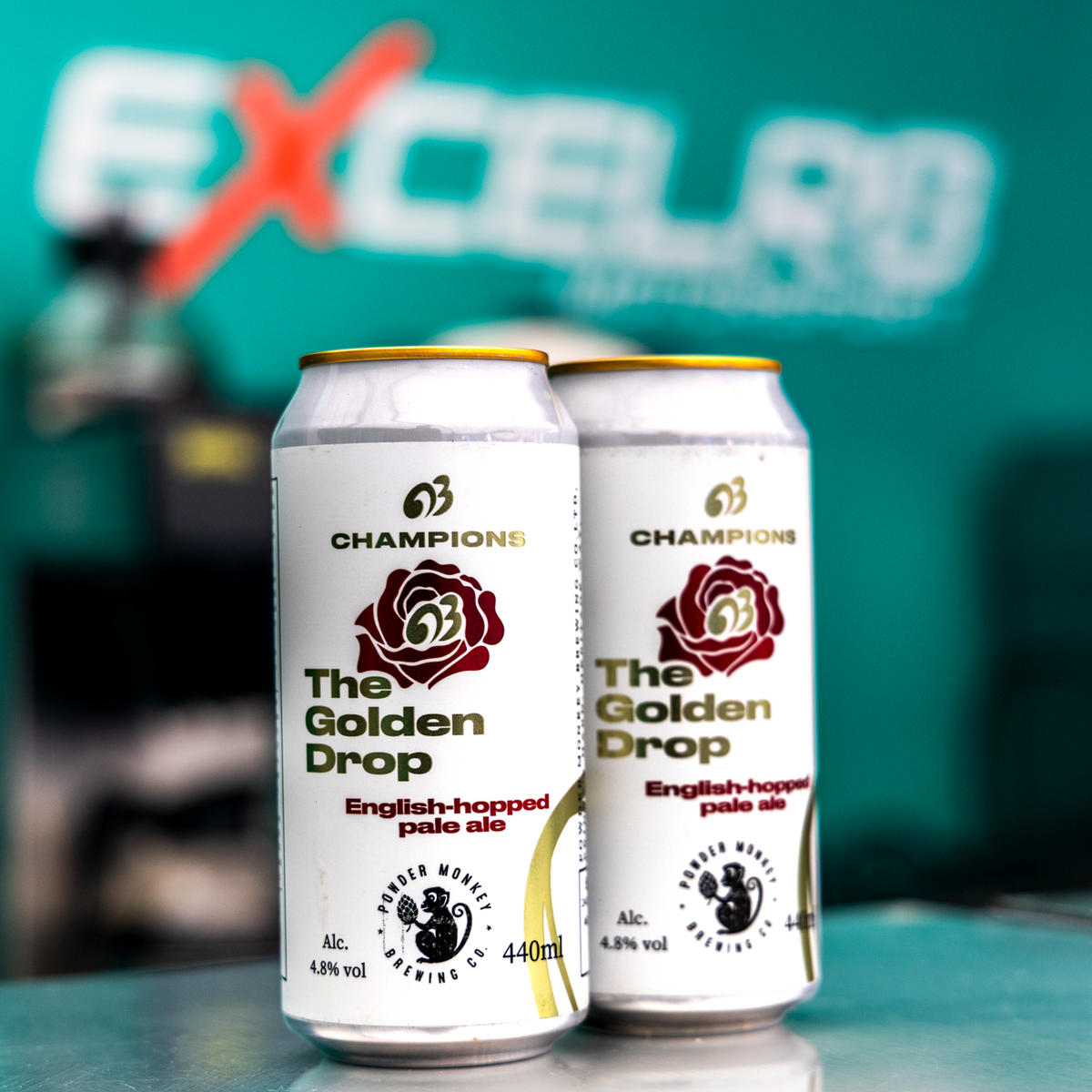 Two cans of CHAMPIONS The Golden Drop pale ale English-hopped pale ale