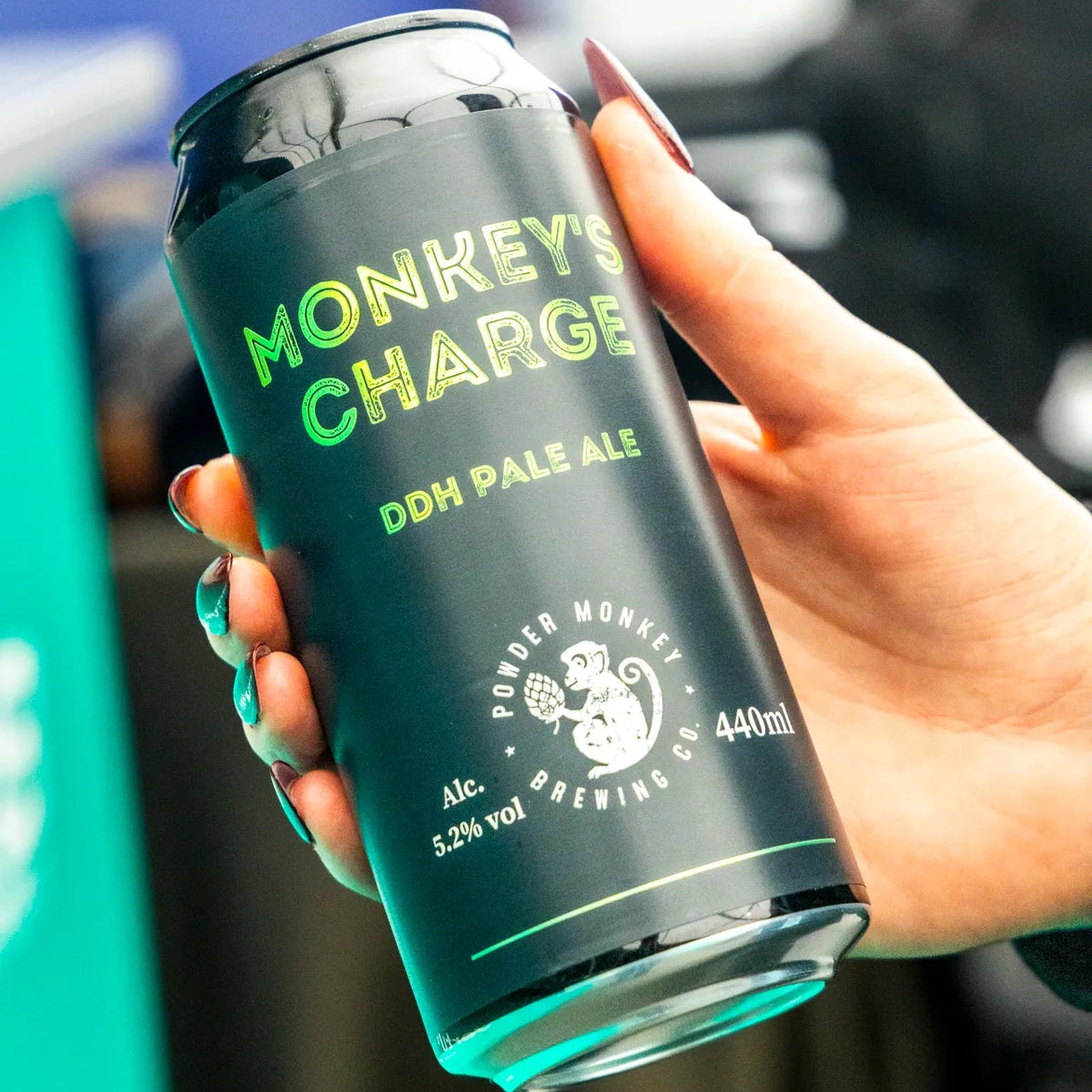 Hand holding can of monkey's charge DDH pale ale